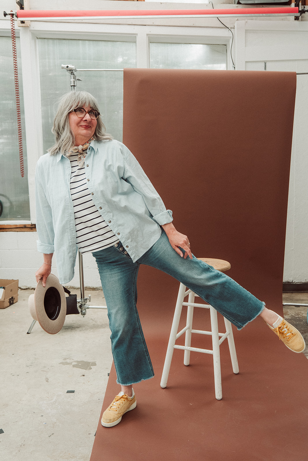 The maker reading, surrounded by a stack of beautiful books